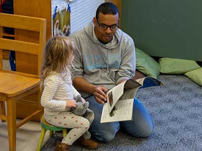 child being read to in nursery school