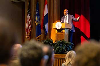 smaller image of Dr. Peter Grant Jordan at lectern